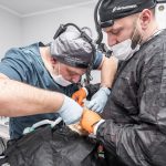 Two dental surgeons focus on a complex procedure in a modern clinic setting.